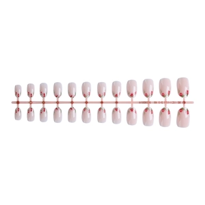 Faux ongles press-on style français avec motifs roses rouges élégants sur base rose