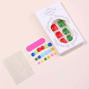 Colorful mix of glossy toenail press-ons with pink nail file and adhesive tabs in box