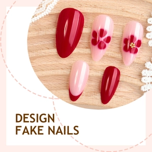 Handmade almond fake nails featuring red floral designs and French tips on wood background