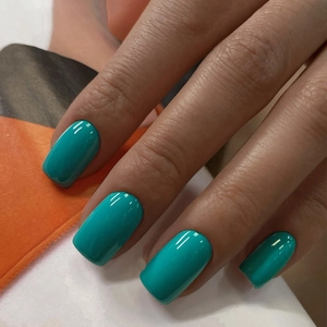 Macro shot of glossy tiffany blue press-on nails in medium square shape with high shine