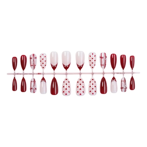 Glossy almond press-on nails set with red checkered patterns and heart designs