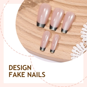 Pink cat eye fake nails with dark green French tips and gold line detail on wood stand