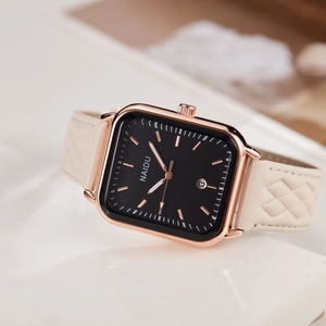 Detail of square rose gold watch with date window and quilted beige leather strap