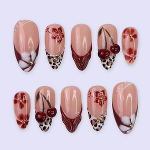 Handmade almond press-on nails featuring burgundy French tips, leopard print, and 3D cherry