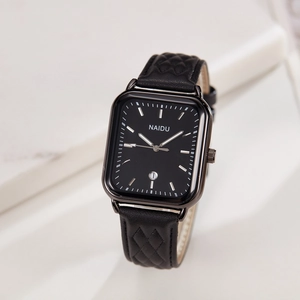 Detail shot of rectangular quartz watch dial with black leather quilted strap and calendar