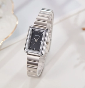 Detailed side view of NAIDU rectangular watch with silver steel band and black dial
