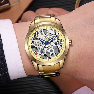 Macro view of gold skeleton watch with mechanical gears and blue luminous hands