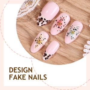 Pink almond press-on nails with 3D floral accents and leopard print on wooden base
