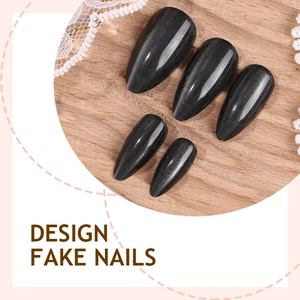 Minimalist black cat eye stiletto fake nails with sparkling starry sky effect on wood