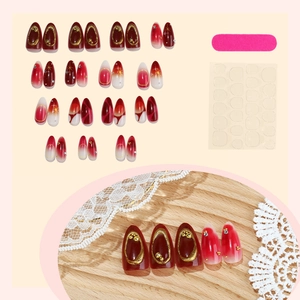 Deep red almond press-on nails with gold foil, marble patterns and adhesive tools set