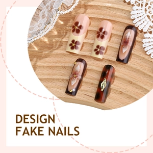 Hand-painted leopard and floral press-on nails with 3D pearls on a rustic wooden tray