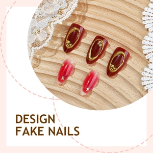 Detail of red almond press-on nails with 3D gold beads and gradient rhinestone accents