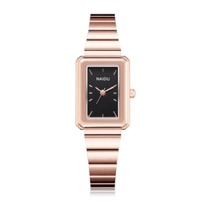 Detail of rectangular rose gold watch with black dial and horizontal link strap