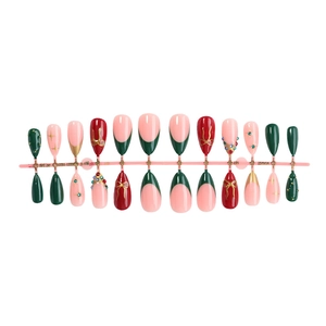 Christmas press-on nails with red French tips, colorful rhinestones and bow designs