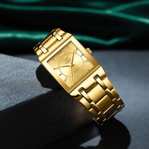 Close-up of golden square quartz watch with stainless steel band on luxury satin background