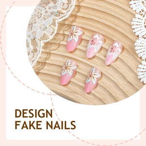 Pink gradient almond fake nails with 3D white floral embossed patterns and lace detail