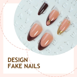 Elegant almond fake nails with maroon gradient, 3D golden stars and pearl accents