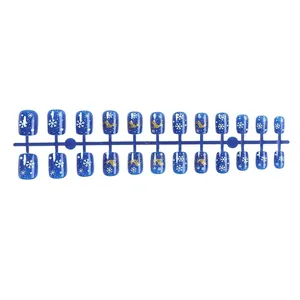 Short Christmas blue press-on nails with white snowflake and gold reindeer designs