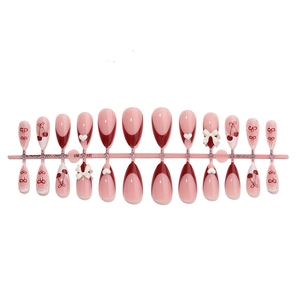 French tip press-on nails set with cherry heart patterns and 3D white bows