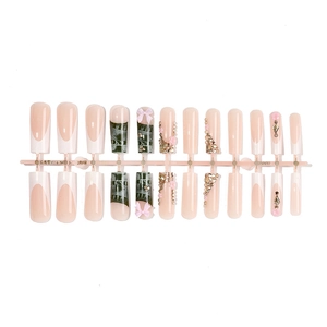 Long coffin press-on nails with dollar motifs, pink bows, and rhinestone accents