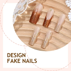 Pink French ombre press-on nails with glitter accents and sparkling rhinestones