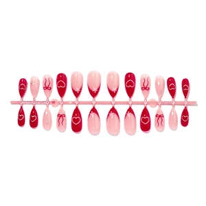 Red almond press-on nails with sweet heart and bow patterns for Valentines Day