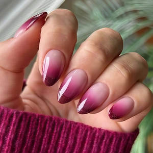 Macro detail of almond-shaped gradient press-on nails with glitter and glossy finish