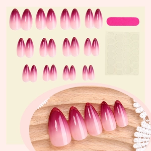 Pink to burgundy gradient almond press-on nails with red glitter tips and application kit