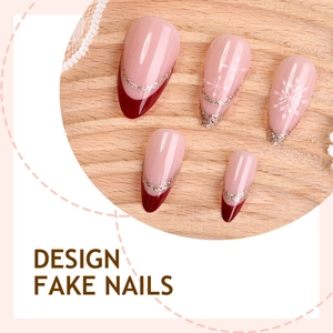 Christmas press-on nails with red French tips, gold glitter, and white snowflake patterns
