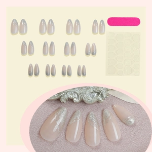 Almond press-on nails set featuring nude base and silver glitter french lines