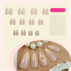 Almond gradient press-on nails with white floral patterns and gold beads kit
