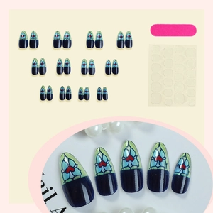 French almond press-on nails with blue stained glass design and red heart accents