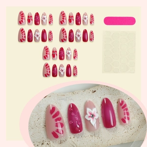 3D floral almond press-on nails with rhinestones and water drops on cream background