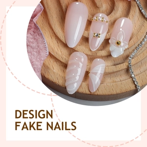 Almond press on nails with white ribbon flowers, pearls and rhinestones on nude base