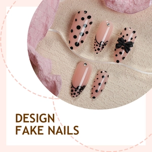 Almond French fake nails with black polka dots, bows and rhinestones on pink base
