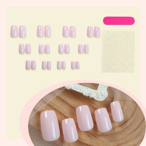 Minimalist glossy light pink press-on nail kit with adhesive tabs and nail file