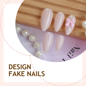 Pink gradient almond press-on nails with delicate 3D bow design on wooden display