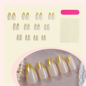 Macro detail of almond-shaped nails with gold wavy French lines and accessory kit