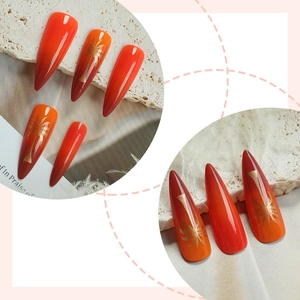 Summer almond press-on nails with orange gradient and golden palm tree patterns