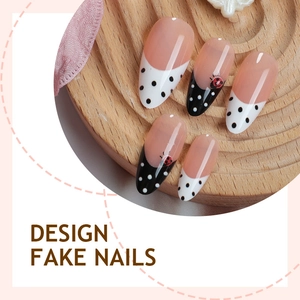 Almond press-on nails with black white dots and ladybug pattern on a wood tray