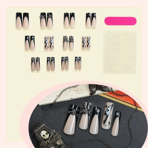 Halloween press-on nails featuring black French tips, 3D skull charms and spider patterns