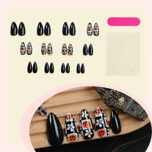 Halloween almond fake nails featuring vintage pumpkin designs and checkered patterns