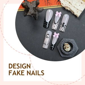 Halloween fake nails set with ghost pumpkin patterns and pink bows on dark stone base