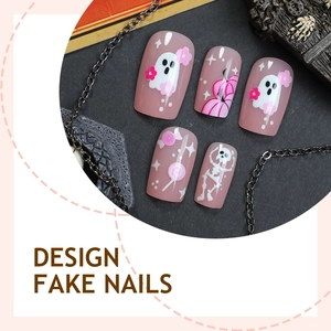 Pink Halloween press-on nails featuring cute cartoon ghost and pumpkin designs