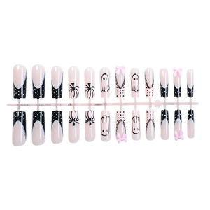 Halloween coffin nails with pink bows, ghost patterns, and black polka dot designs