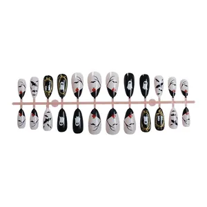 Halloween 3D press-on nails set featuring almond ghost and bat patterns with gold accents