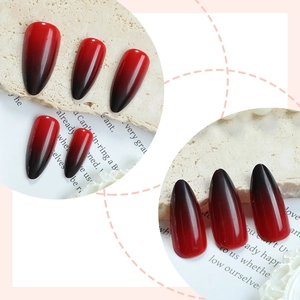 Glossy red and black gradient almond shaped press-on nails with shiny finish