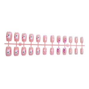 Pink Halloween press-on nails featuring cartoon ghost, pumpkin, and skull patterns