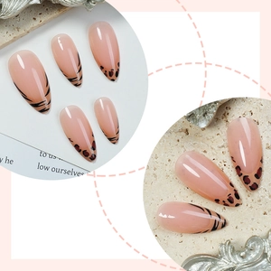 Glossy almond press-on nails with nude base featuring leopard and tiger print tips
