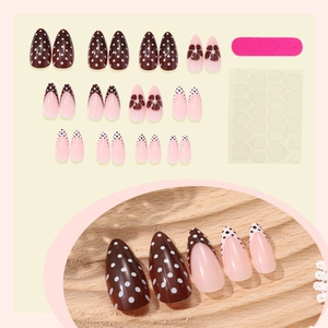 French tip press-on nails with brown polka dots and floral art including DIY tool kit